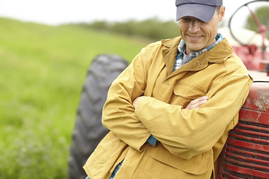 Man by Tractor - Wondering about Satellite Internet